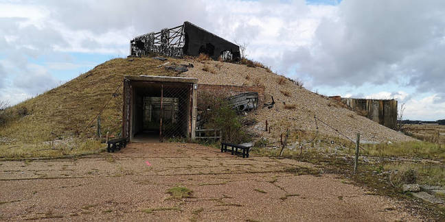 The outside the AWRE Lab 1. Note the shingle piled up to contain explosions